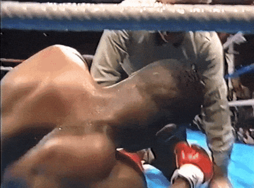 Man in Boxing Ring With Referee