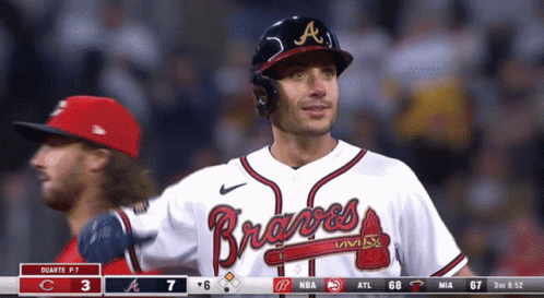 Man in Braves Jersey Standing in Outfield