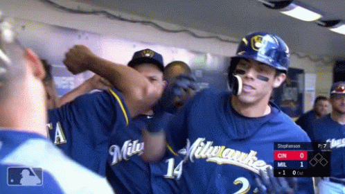 Man in Brewers Jersey High Fiving Another