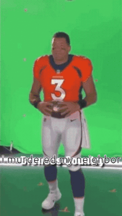 Man in Broncos Jersey Holding Football
