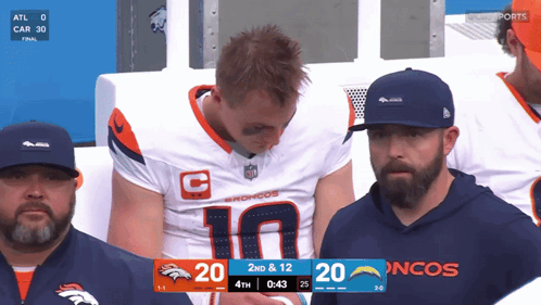Man in Broncos Jersey Watching Game