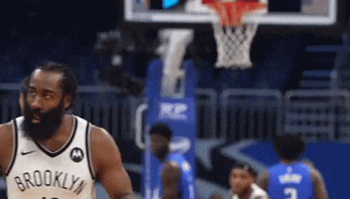 Man in Brooklyn Jersey Playing Basketball