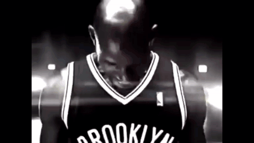 Man In Brooklyn Nets Jersey In Dark Room GIF