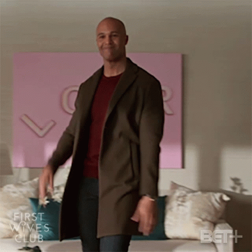 Man in Brown Coat in Front of Couch First Wives Club