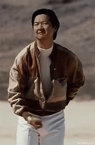 Man in Brown Jacket and White Shorts in Field