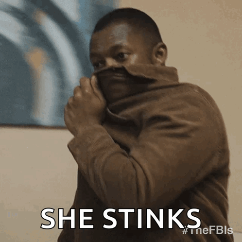 Man In Brown Jacket Covering Face GIF