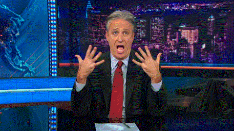 Man In Brown Jacket Holding Green Light GIF