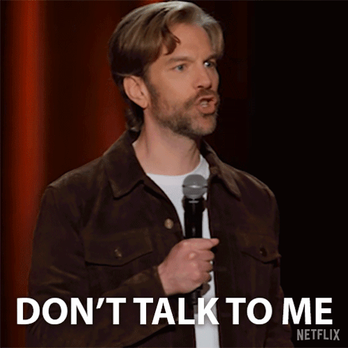 Man in Brown Jacket Holding Microphone Says Don't Talk to Me