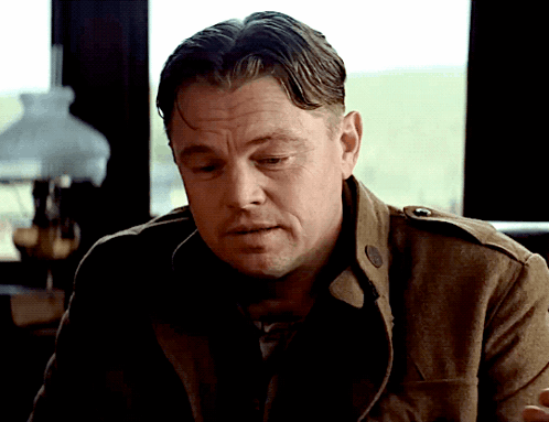 Man In Brown Jacket Looking Down GIF