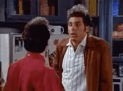 Man in Brown Jacket Next to Woman in Red Dress