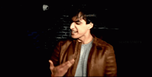 Man in Brown Leather Jacket With Silver Screen