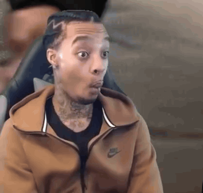 Man in Brown Nike Jacket Sitting Mouth Open