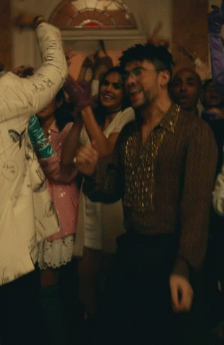 Man in Brown Shirt Surrounded by People