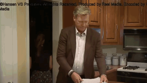 Man In Brown Suit At Stove GIF