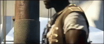 Man In Brown Vest Standing GIF