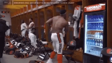 Man in Browns Uniform Standing Next to Gatorade Cooler