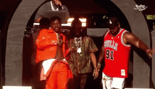 Man in Bulls 91 Jersey With Two Others on Stage