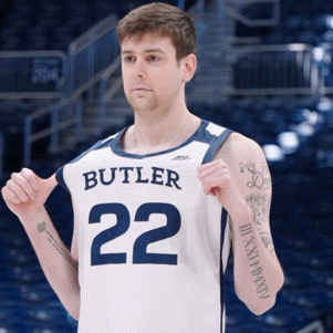 Man in Butler 22 Jersey Holding Shirt Up