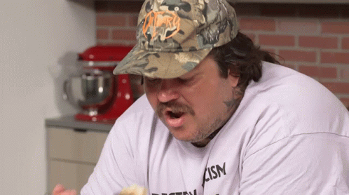 Man in Camo Hat and T-Shirt Saying Ism