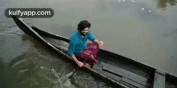 Man In Canoe With National Geographic Logo GIF