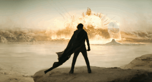 Man in Cape Facing Huge Explosion