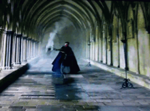 Man in Cape Walking Down Hallway