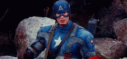 Man in Captain America Costume Sitting on Rock With Shield