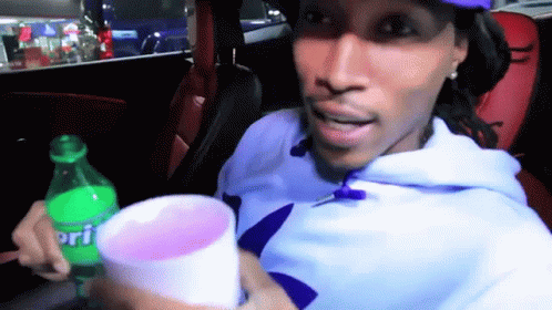 Man in Car Holding Sprite Bottle and Cup