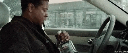 Man in Car Holding Water Bottle