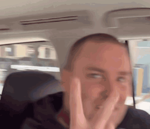Man in Car Making Peace Sign