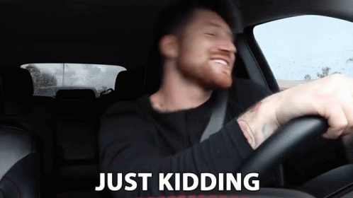 Man In Car Saying Just Kidding GIF