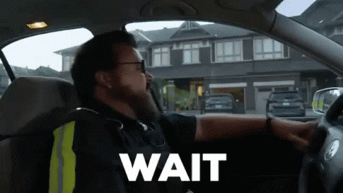 Man in Car Saying Wait