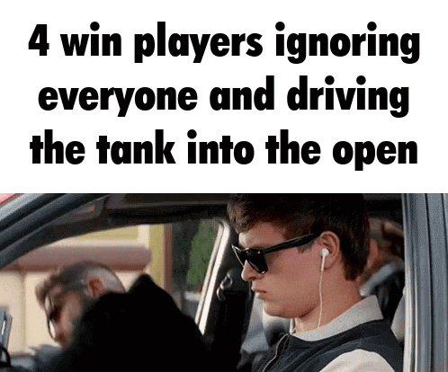 Man in Car with 4 Win Players Ignoring Driving Tank