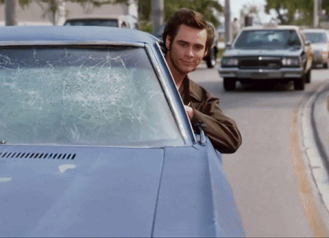 Man in Car With Broken Windshield