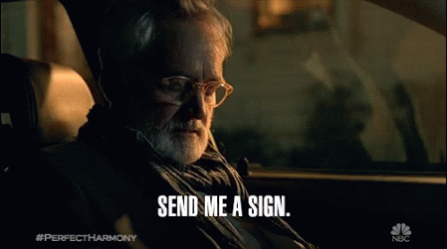 Man in Car with Send Me a Sign