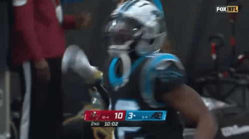 Man in Carolina Panthers Uniform Smoking Cigarette