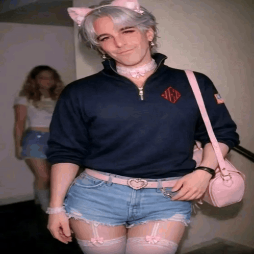 Man in Cat Ear Headband and Shorts With Pink Bag
