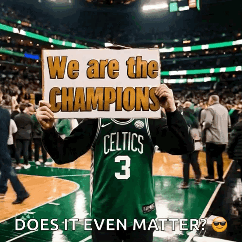 Man in Celtics Jersey Holding We Are The Champions Sign