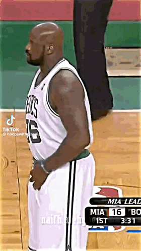 Man in Celtics Jersey on Basketball Court