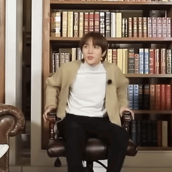 Man In Chair By Bookshelf GIF