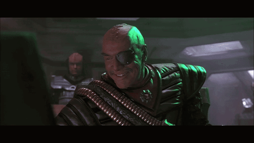 Man In Chair Saying And Let Slip The Dogs Of War GIF