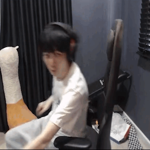 Man In Chair With Headphones And Stuffed Animal GIF