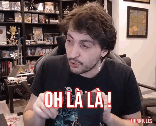 Man In Chair With Oh La La Shirt GIF