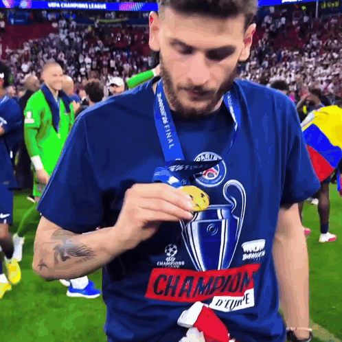 Man In Champions League T-Shirt Holding Medal GIF