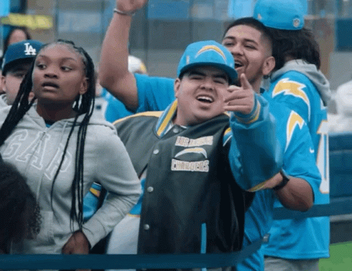 Man In Chargers Jacket Pointing GIF