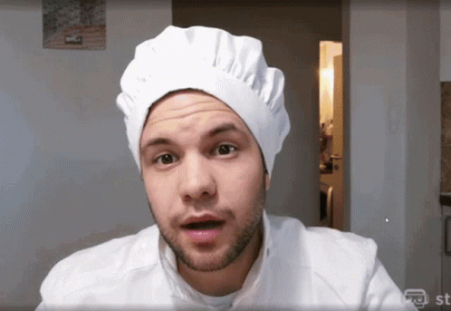 Man in Chef Hat and White Shirt