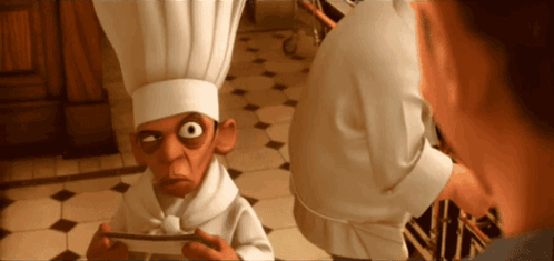 Man in Chef Hat Looking at Man in White Shirt