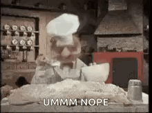 Man in Chef Hat Sitting With Dough