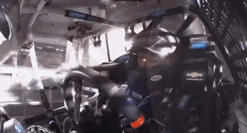 Man In Chevrolet Helmet Driving Race Car GIF