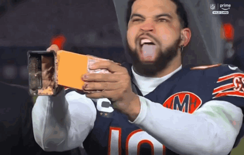 Man in Chicago Bears Jersey Holding Box of Cheese